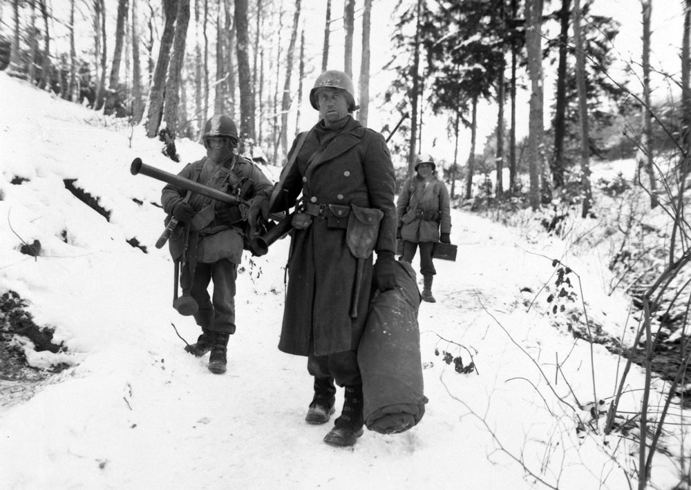 Engineers from the 101st emerge from the woods.