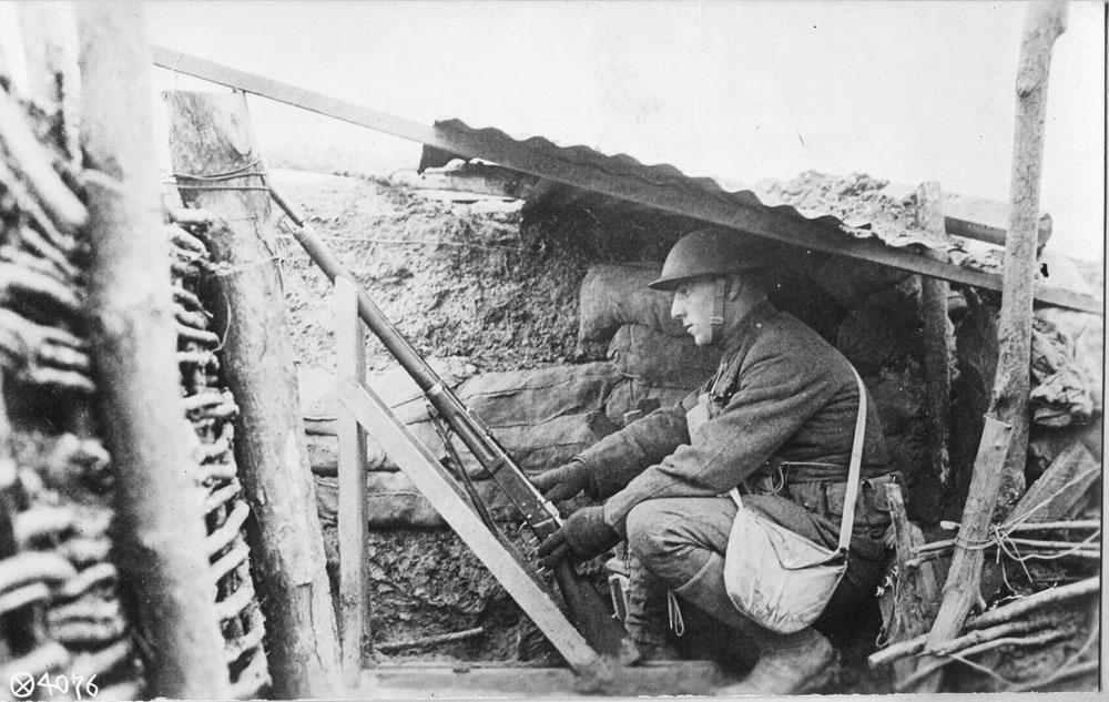 Soldier in a trench operating a signal gun.