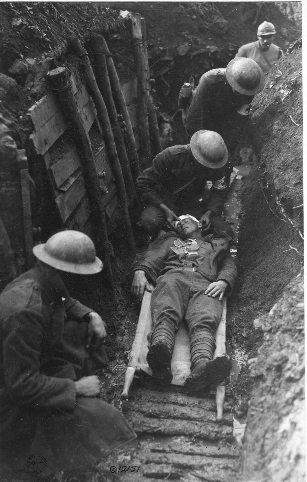 A Marine receiving first aid in a trench.