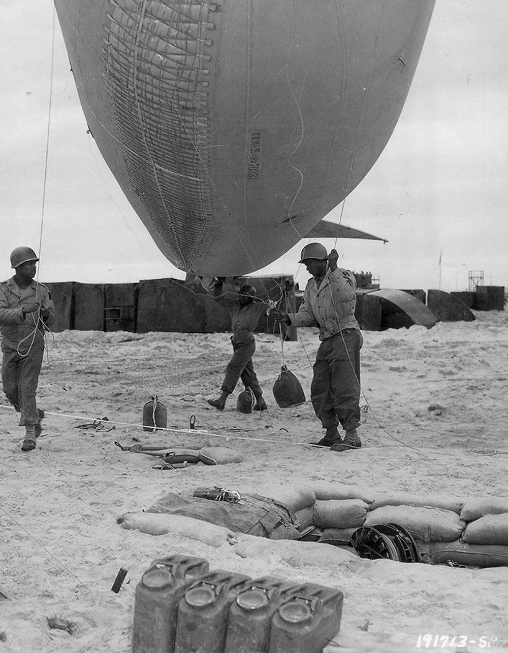 Soldiers of the 320th Barrage Balloon Battalion prepare to deploy a balloon on Omaha Beach.