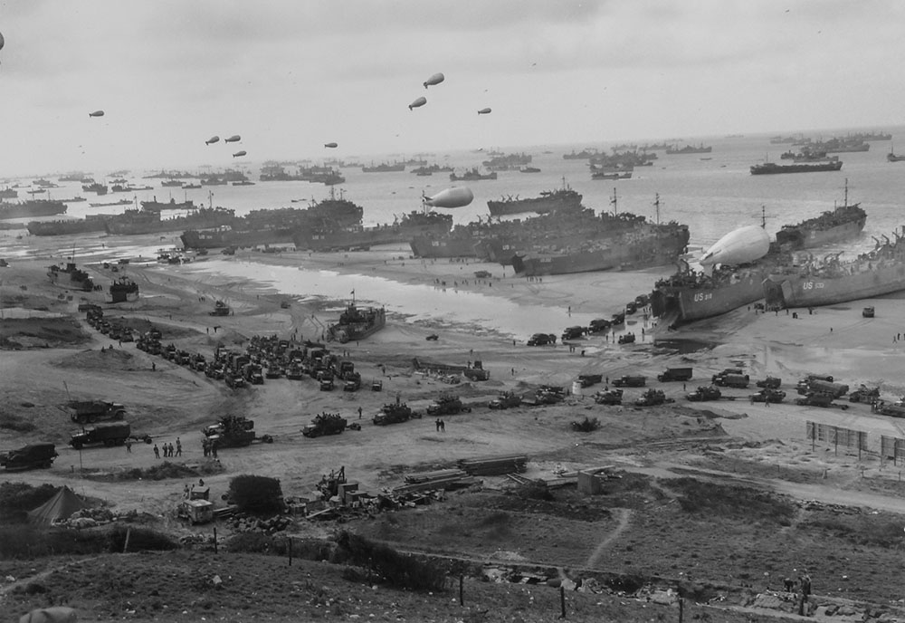 Headed inland are long parades of trucks, loaded with troops and supplies.