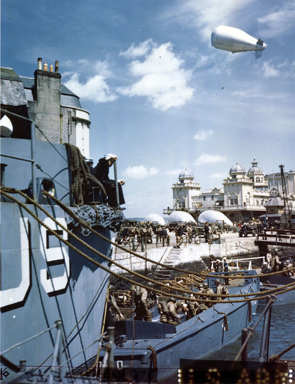 American troops at a British port descend into barges which will take them to troop to Hitler's Fortress Europe.