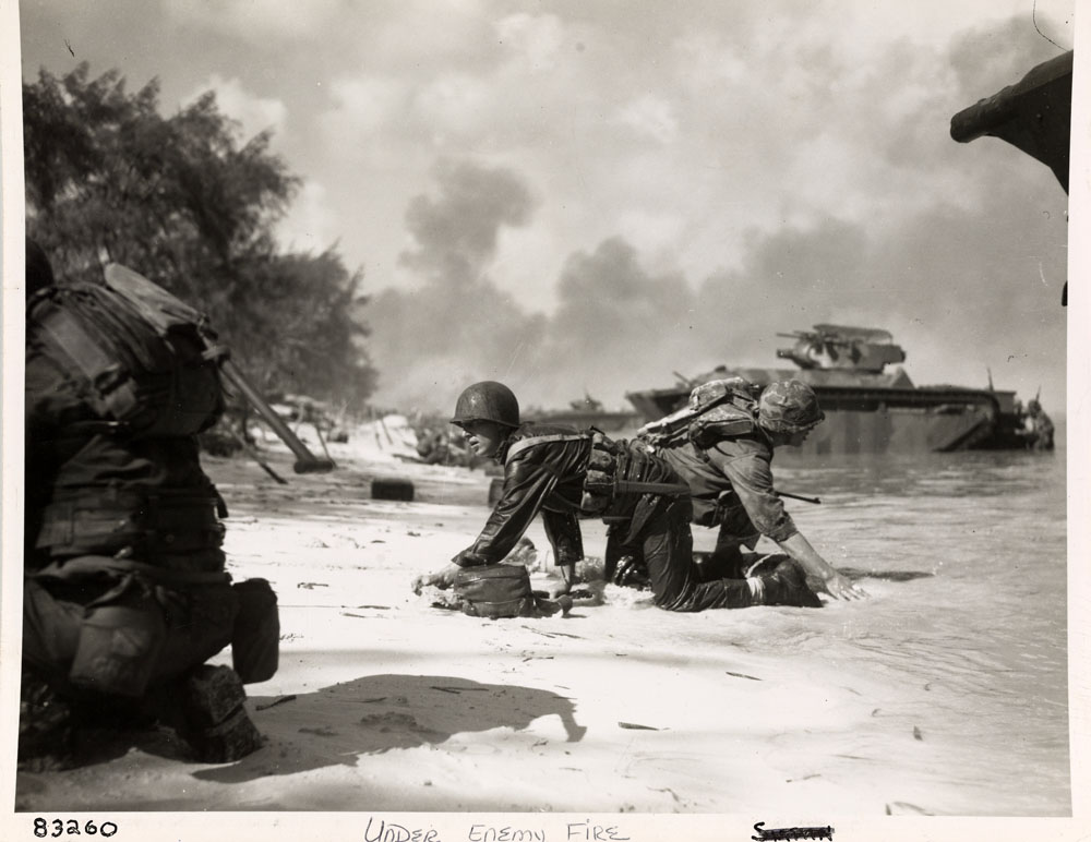 Marines landing on Saipan under enemy fire from Japanese forces.