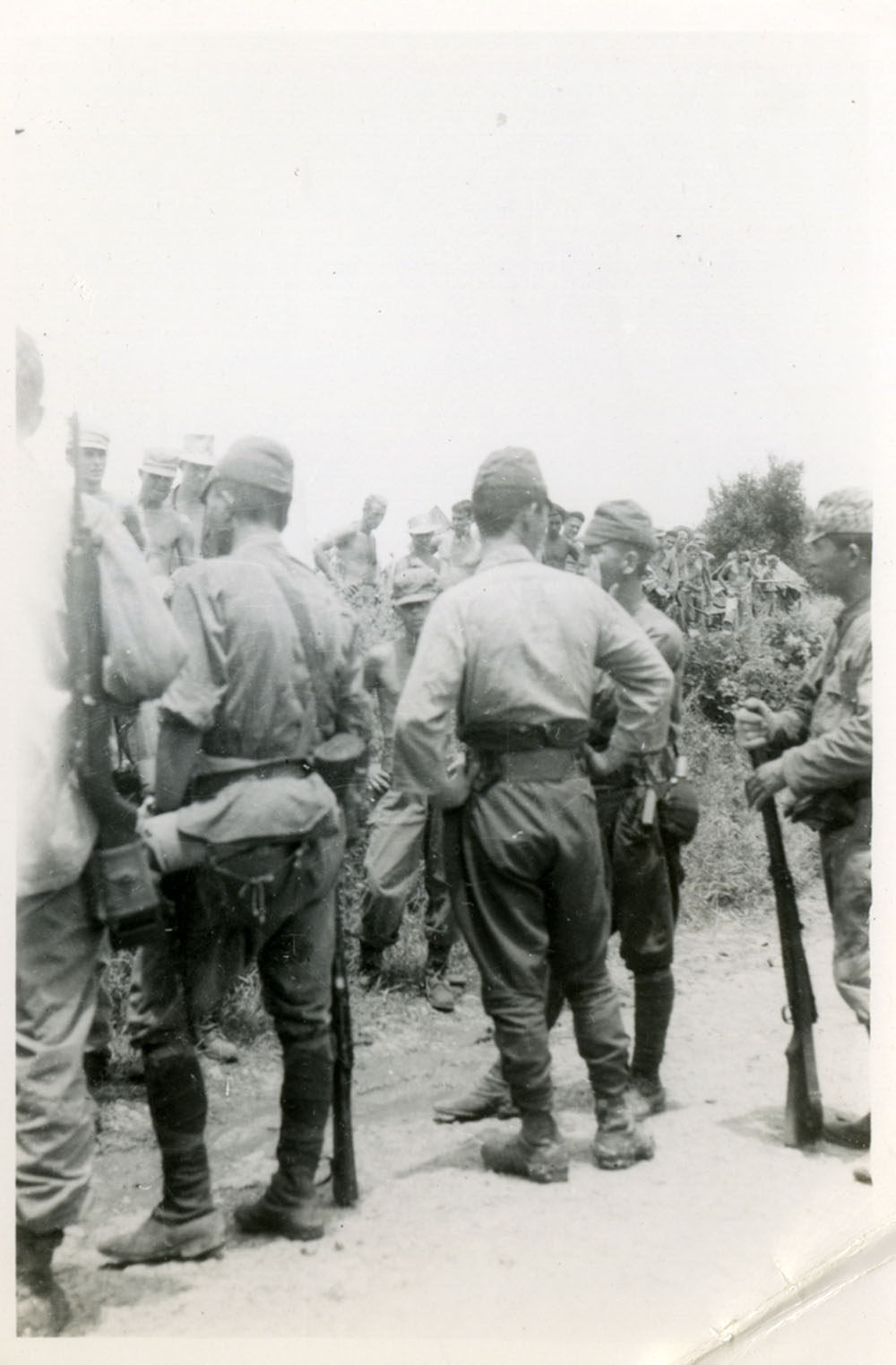 Japanese soldiers wait to surrender.