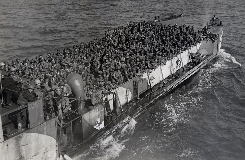 Reinforcements for Normandy Beachhead U. S. soldiers crowd into every inch of space aboard this LCT (Landing Craft, Tank), which is making continuous runs from transports to the Allied beachhead on the Normandy coast.