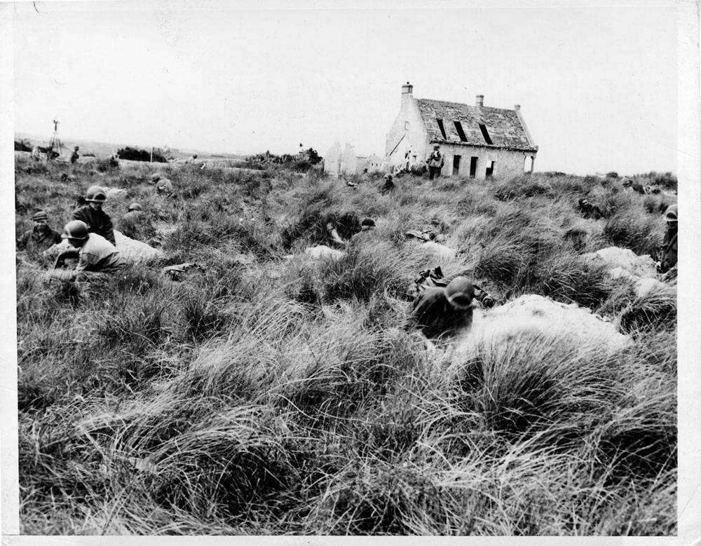 American soldiers who have pushed forward from the beaches, dig themselves in against counterattack in the fields inland. This is the original of a radio previously serviced.