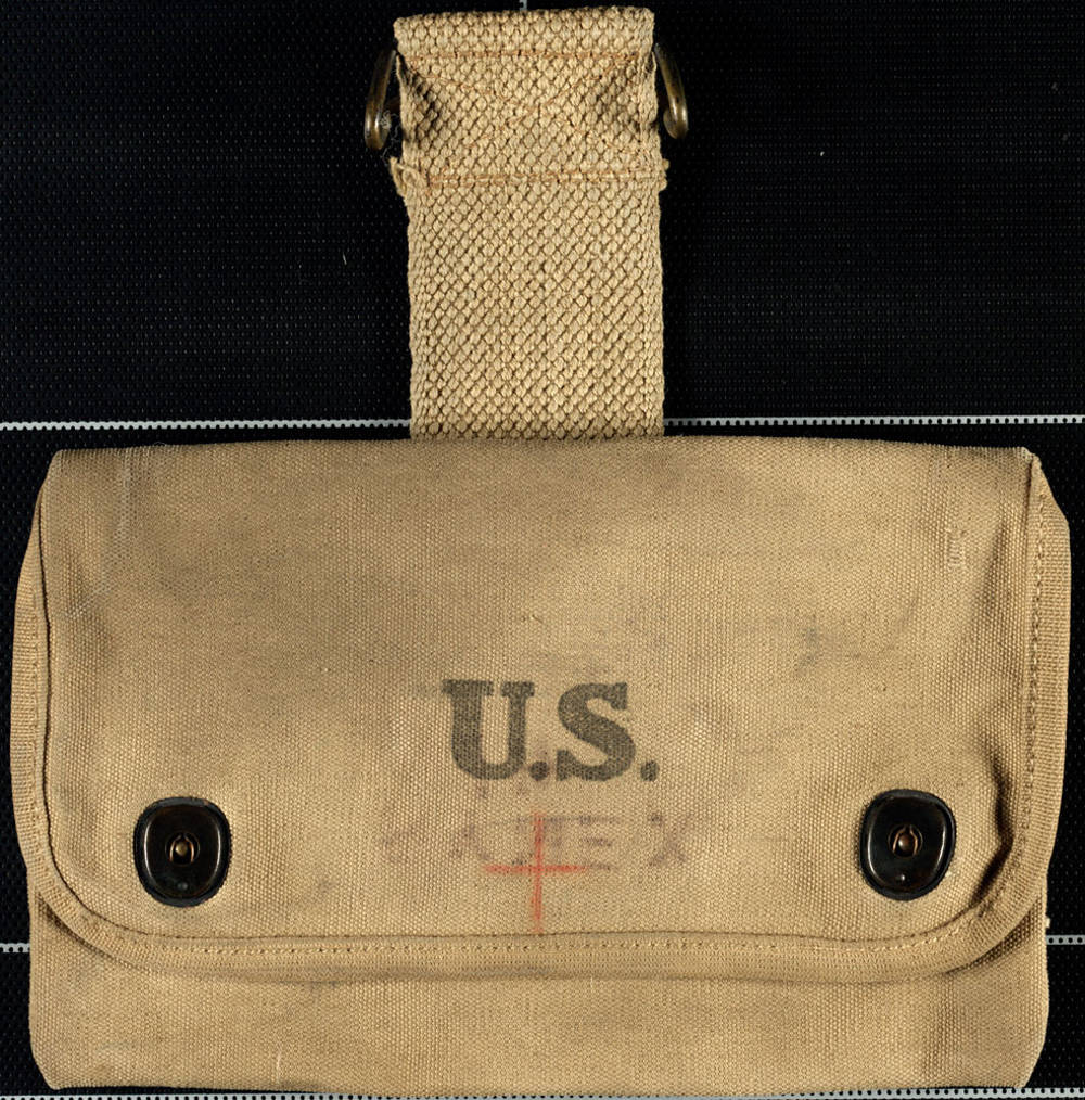 This particular pouch may have been used to carry medical equipment, as evidenced by the red cross drawn on the front.