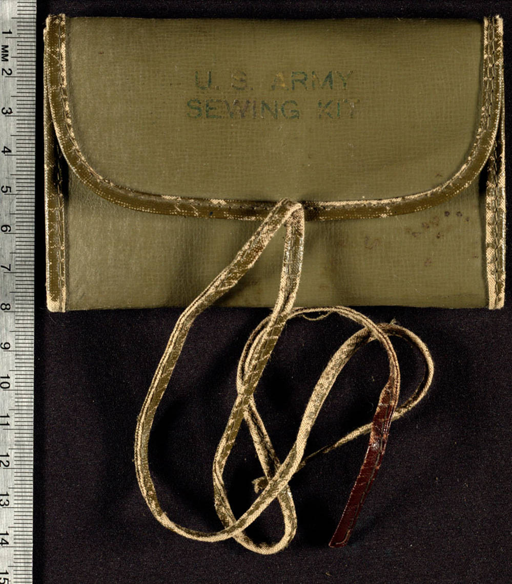 Leather kit is fold able and contains thread, a safety pin, a button, and needles.