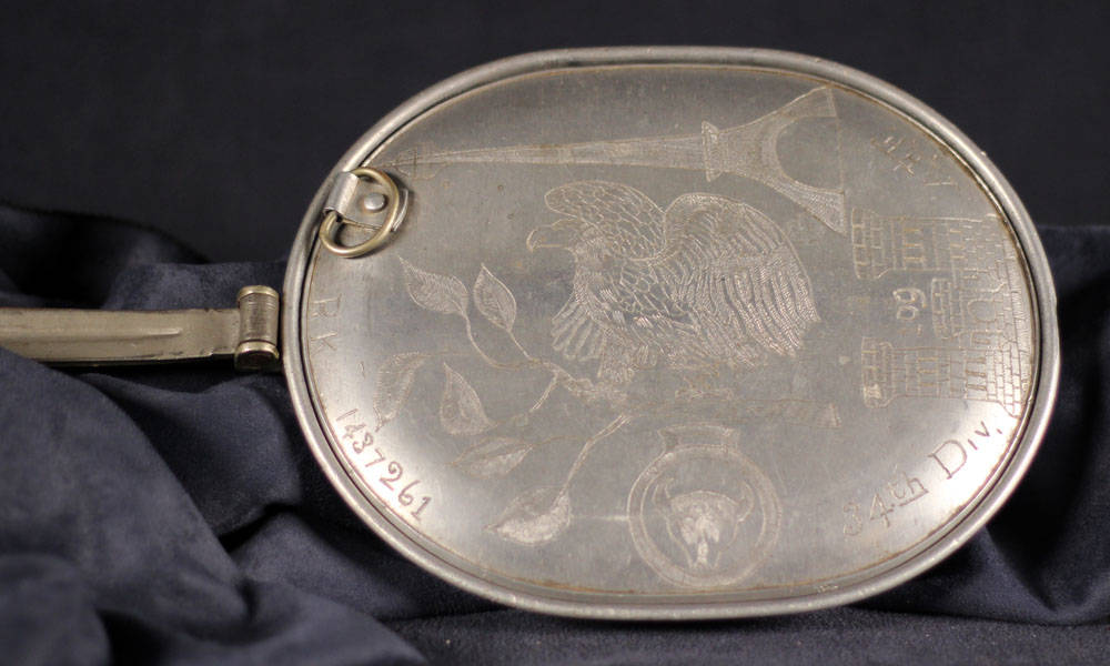 Mess kit with an engraved eagle perched on a branch.