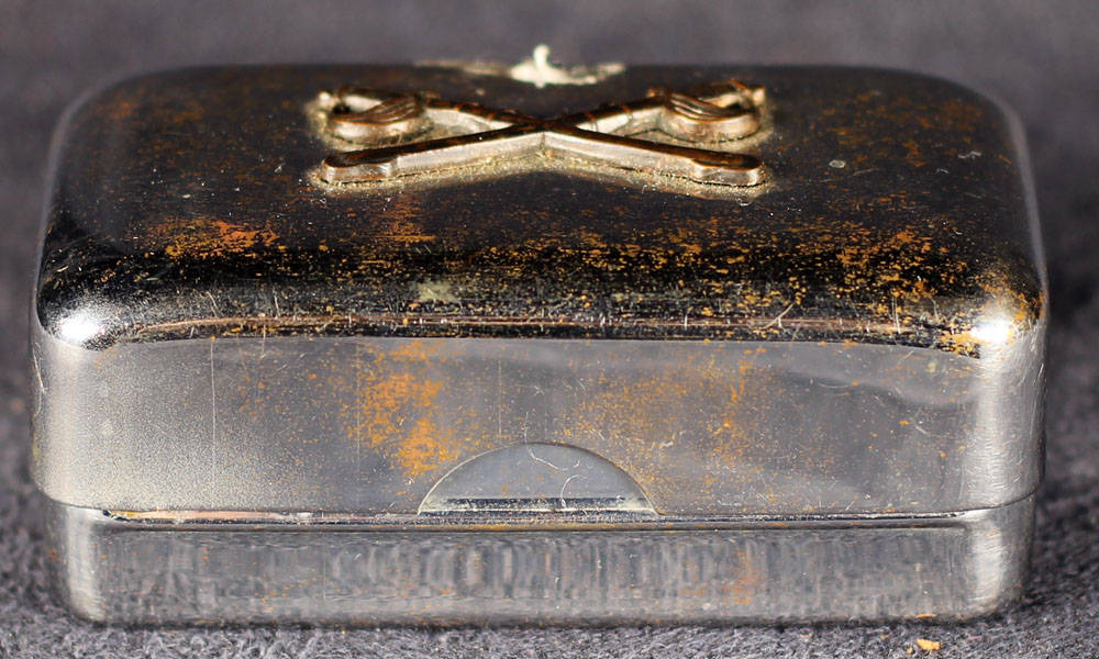 Metal soap dish with soap.