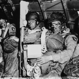Resolute faces of paratroopers just before they took off for the initial assault of D-Day.
