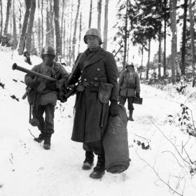 Engineers from the 101st emerge from the woods.