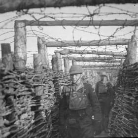 Soldiers from 166th Infantry Regiment passing through a trench.