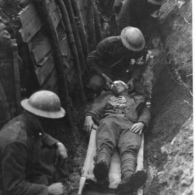 A Marine receiving first aid in a trench.