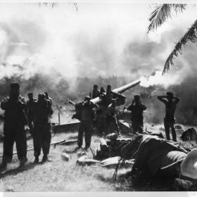 American forces firing artillery at Japanese defenses during the Philippine Campaign.  