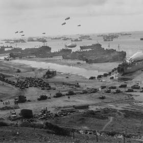 Headed inland are long parades of trucks, loaded with troops and supplies.