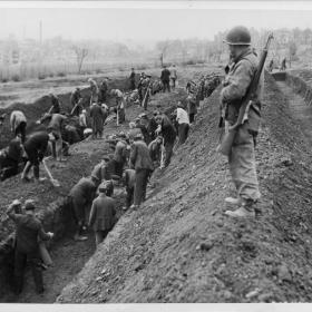 German citizens forced to dig graves for victims discovered at the Dora-Mittelbau camp.