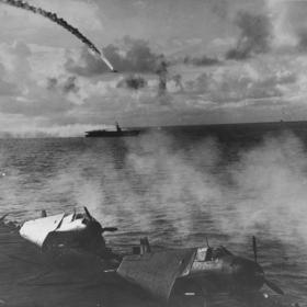 Japanese plane being shot down while attempting to attack USS Kitkun Bay during the Battle of the Philippine Sea.
