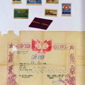 Propaganda postage stamps, a piece of North Vietnamese uniform insignia, and a certificate written in Vietnamese