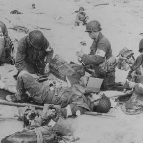 American Medics render first aid to troops in the initial landing on Utah Beach. 