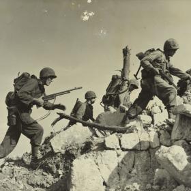 United States Marine scale rough terrain on Okinawa.