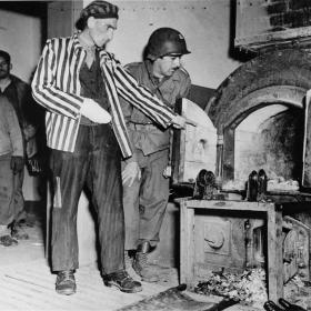 Dora-Mittelbau camp survivor shows solder John L Lyndon the crematorium ovens.