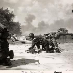 Marines landing on Saipan under enemy fire from Japanese forces.