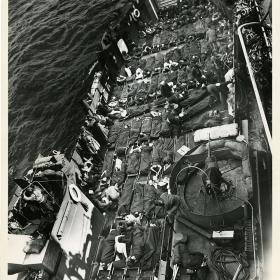 Row and row of stretchers cover the decks of a Coast Guard LCT (Landing Craft Tank) bringing out wounded invaders from the flaming soil of France.