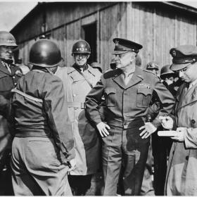 Generals Eisenhower, Patton and Bradely meet to inspect Ohrdruf concentration camp.