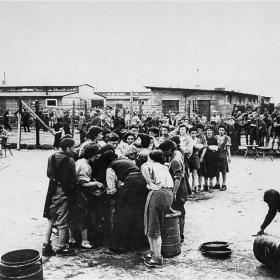 Liberated women survivors queue up for soup.