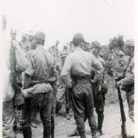 Japanese soldiers wait to surrender. 