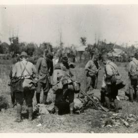 Surrendered Japanese soldiers lay down their arms. 