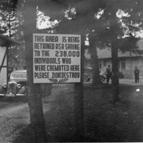 Memorial sign in front of the crematorium at Dachau concentration camp.