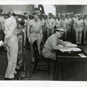Admiral Nimitz signs surrender documents. 