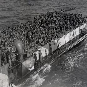 Reinforcements for Normandy Beachhead U. S. soldiers crowd into every inch of space aboard this LCT (Landing Craft, Tank), which is making continuous runs from transports to the Allied beachhead on the Normandy coast.