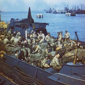 One of the many types of vessels used to transport American soldiers was a Landing Craft, Tank (LCT), shown here with soldiers packed in among vehicles and supplies.