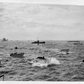 Landing craft of all types head through a choppy sea for the invasion beachhead along the coast of Normandy, during the early hours of the Allied landings. 