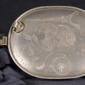 Mess kit with an engraved eagle perched on a branch.