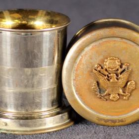 Collapsible drinking cup with U.S. Seal.