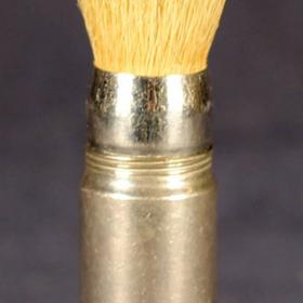 Metal shaving brush with screw-on handle.